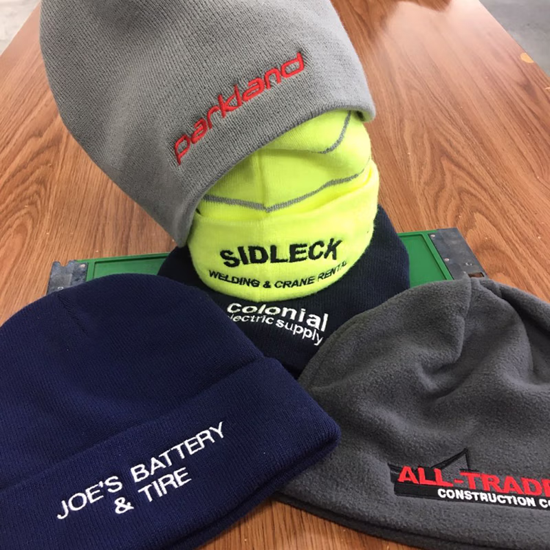 a group of embroidered beanies